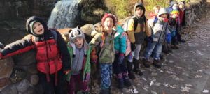 A group of students pose together at Minnehaha Falls.