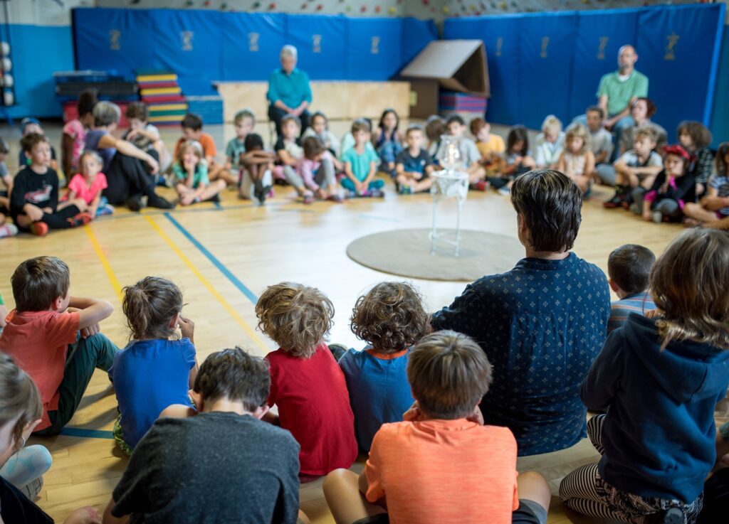 Teachers and students meet for silent worship together in the gym.